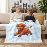 Grandmother and grandson under a baby blue running Highland cow blanket with the name Noah