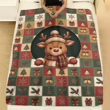 Cozy Reindeer Holiday Squares holiday throw blanket spread across a made bed with white linen, showing a smiling reindeer